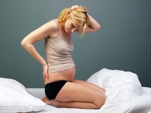 Почему может болеть копчик при беременности